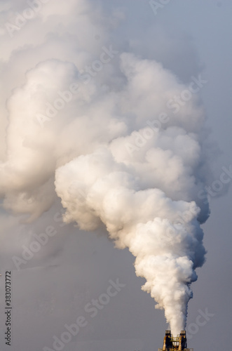 Industrial pollution smoke out of a chimney, conceptual image for zero emission, safe the planet concept ,industrial pollution