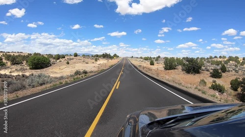 Driving POV on straight secluded highway in scrubby American desert photo
