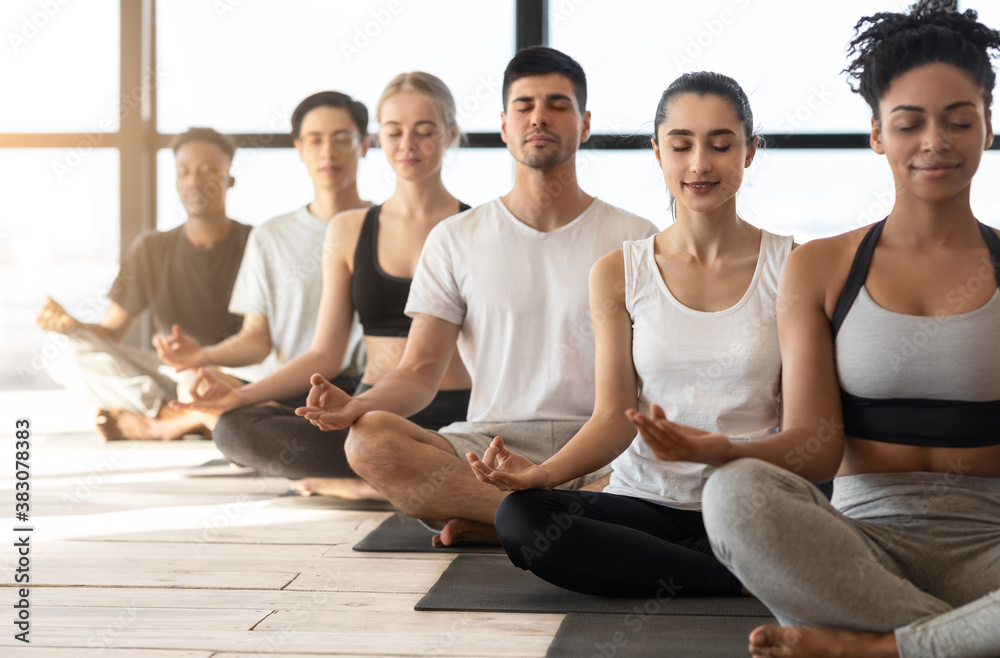 Group Meditation. Sporty Multiracial Men And Women Meditating Together During Yoga Class - obrazy, fototapety, plakaty 
