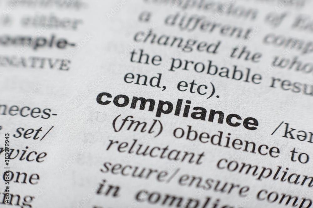 Dictionary definition of the word COMPLIANCE. Close-up shot Dictionary definition of the word COMPLIANCE. Close-up shot