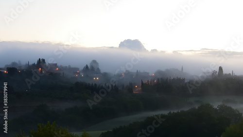 village in the fog in Tuscany
