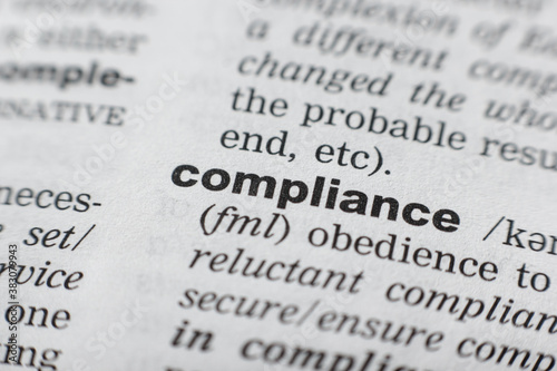 Dictionary definition of the word COMPLIANCE. Close-up shot