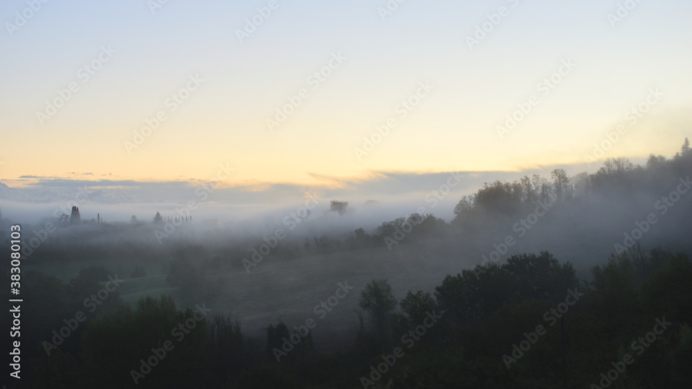 village in the fog in Tuscany