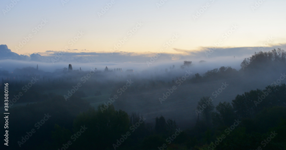 village in the fog in Tuscany