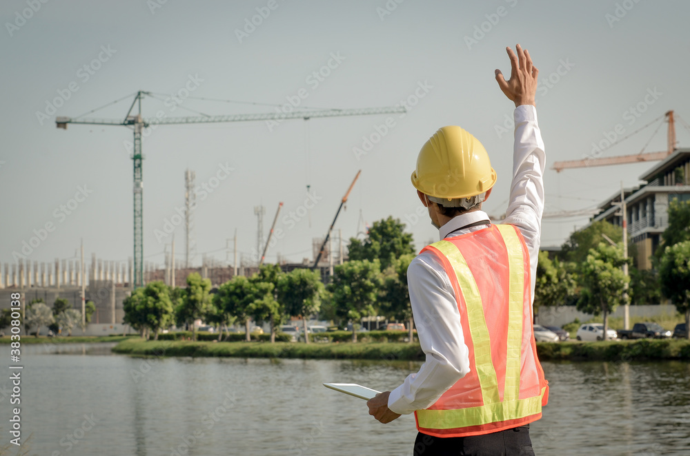 Construction engineer make hand signals while working on the construction site. Construction engineer make hand signals while working on the construction site.