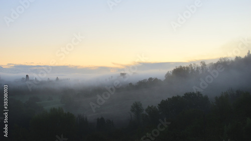 village in the fog in Tuscany