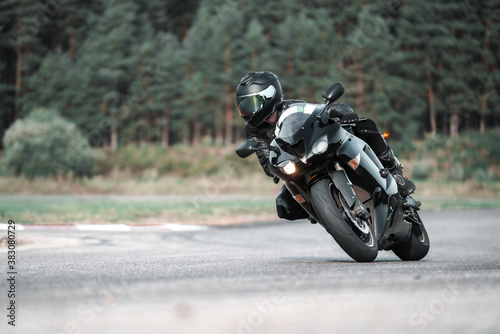 Fast Motorcycle road riding. having fun driving the empty highway on a motorbike tour journey. Black an White photo