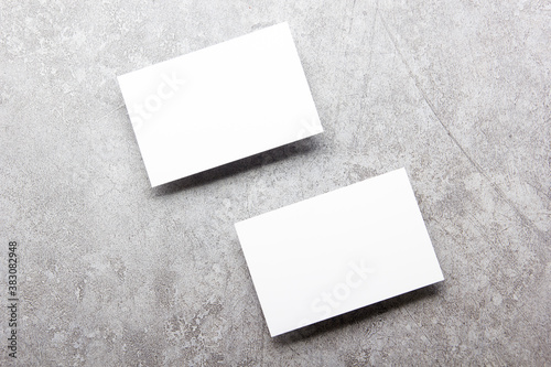 White business cards blank on textured background. Identity design, corporate templates, company style. Flat lay