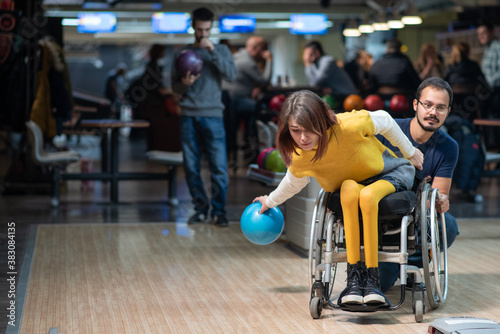 Young disabled woman in a wheelchair bowling