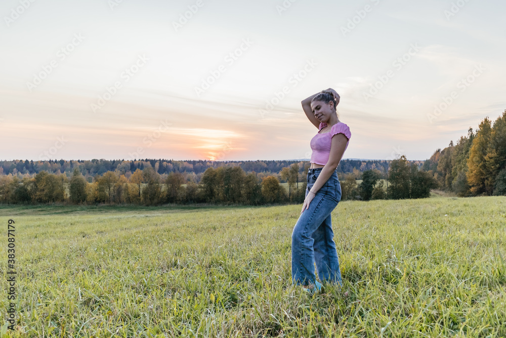Girl posing in a field at sunset  figure attractive nature