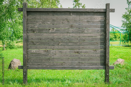 Tableau sur toile Empty brown wooden billboard, nature scenery. Mock up.
