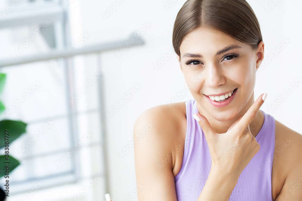 Partial portrait of girl with strong white teeth looking at camera and smiling Partial portrait of girl with strong white teeth looking at camera and smiling