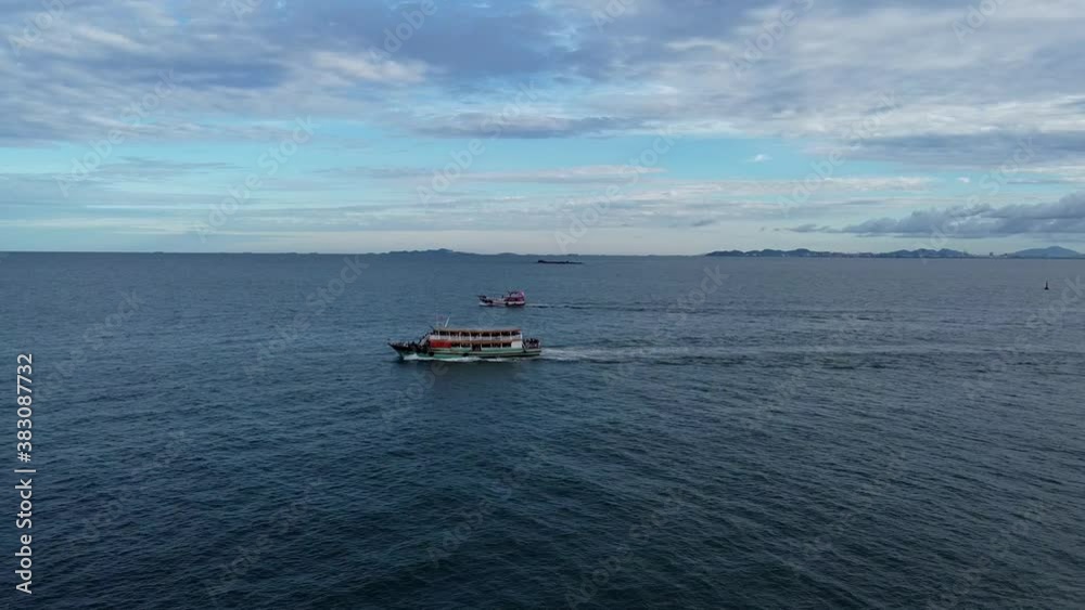 Tracking wooden Thai passenger ferry heading out to islands at dawn
