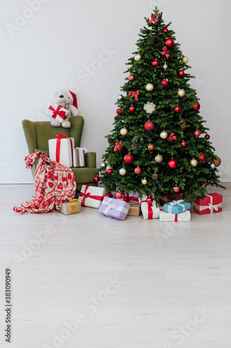 Christmas tree with gifts pine new year decor interior of the house postcard