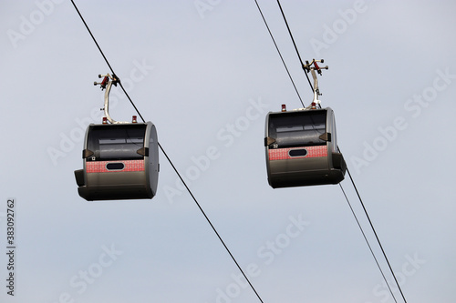 Cable car cabins on sky background. Ropeway gondola close up