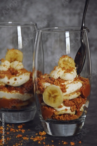 Banoffee sandae in the glass on the dark background photo