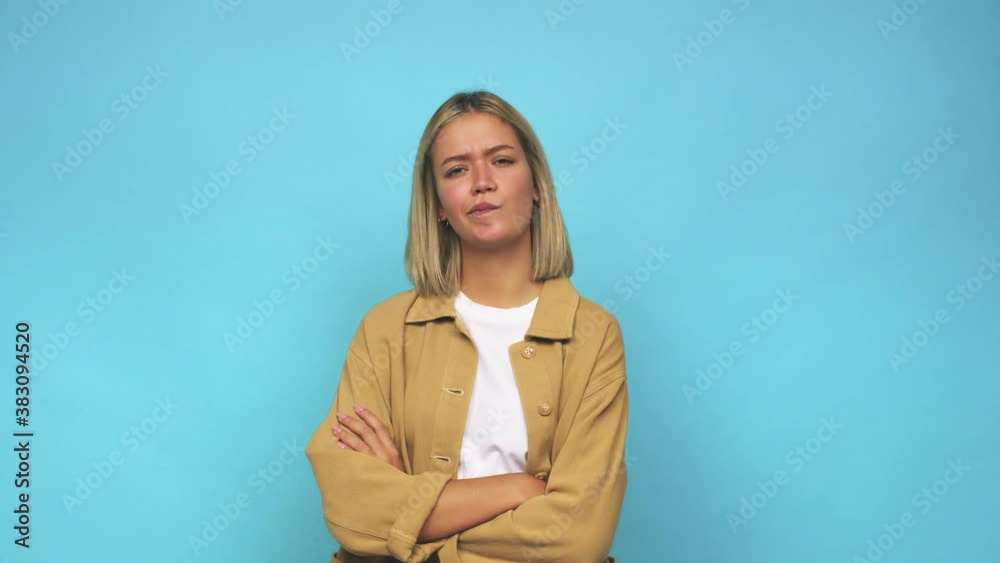 Young blonde caucasian woman unhappy looking in camera with sarcastic expression Young blonde caucasian woman unhappy looking in camera with sarcastic expression