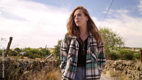 Travelling of a good-looking model walking and looking the camera