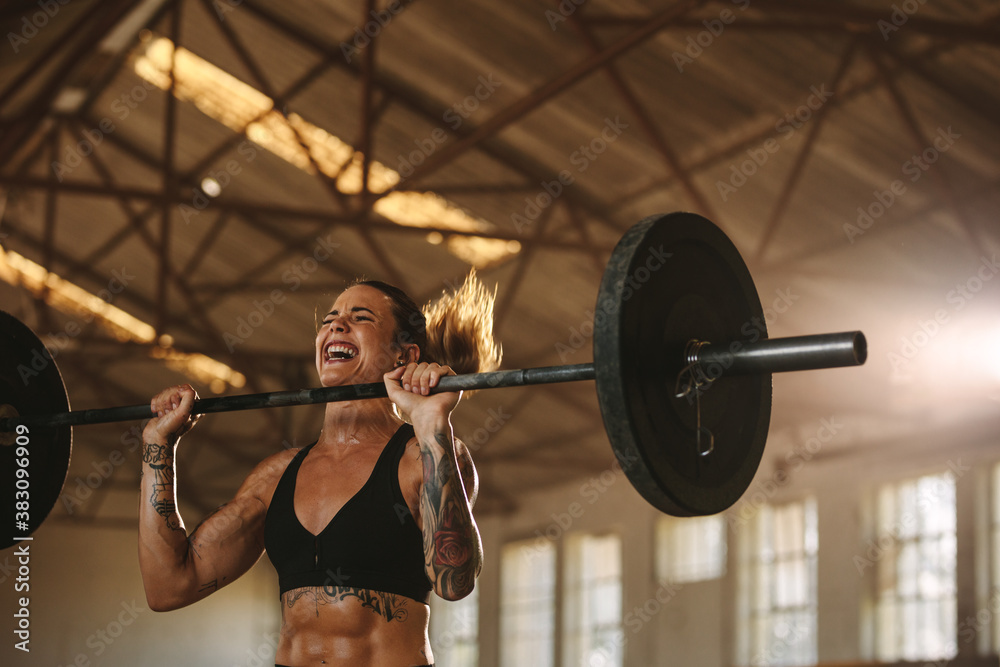 Bodybuilder woman doing weight lifting workout - obrazy, fototapety, plakaty 
