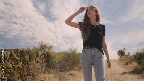 Travelling of a beautiful woman walking and enjoying the environment, takes off her sunglasses