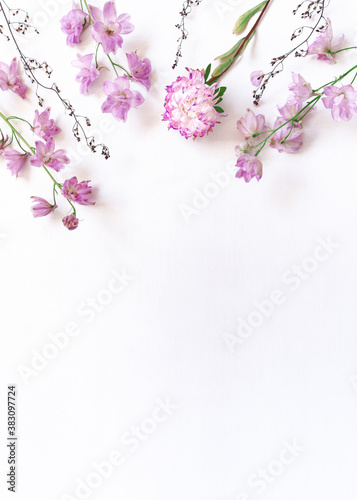 Autumn flower arrangement. Aster and delphinium flowers are on a white chipped background. Flat lay. Top view. Copy space.