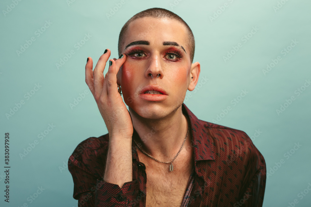 Gender fluid male fixing his makeup Gender fluid male fixing his makeup