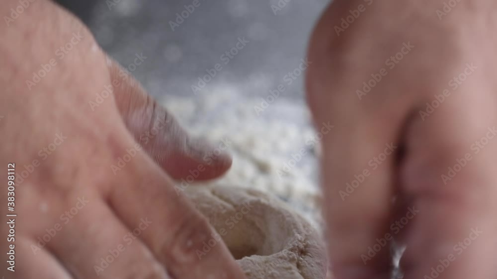 Baker kneads the dough with his fingers, close up Baker kneads the dough with his fingers, close up
