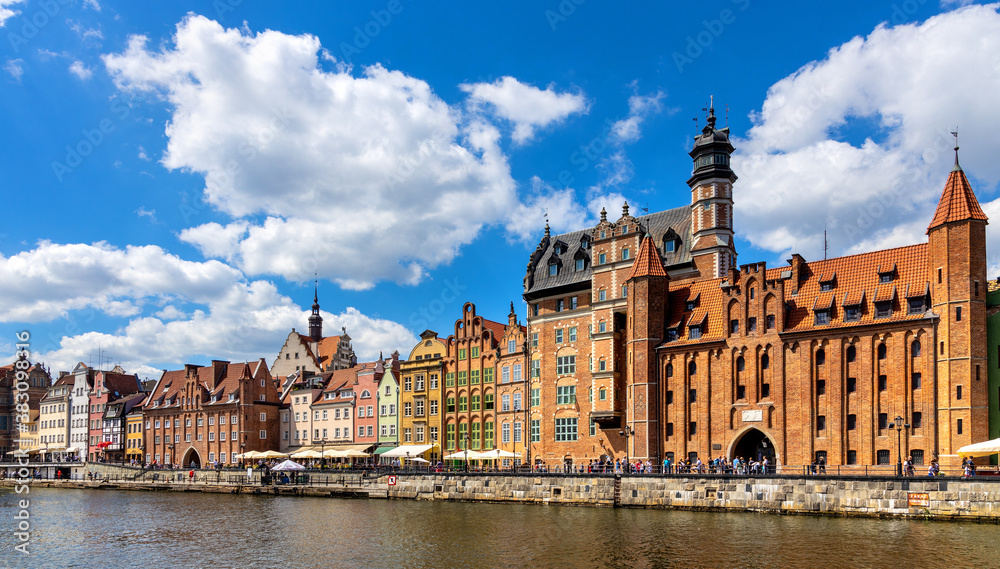 Mariacka Gate and Archeological Museum along the Hanseatic houses pier at Motlawa river embankment in old town city center in Gdansk, Poland
