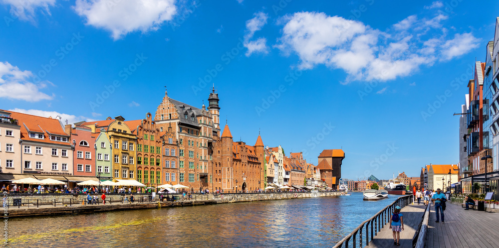 Panoramic view of old town city center at Motlawa river with Hanseatic tenement houses, historic port crane, Maritime Museum and Soldek ship in Gdansk, Poland