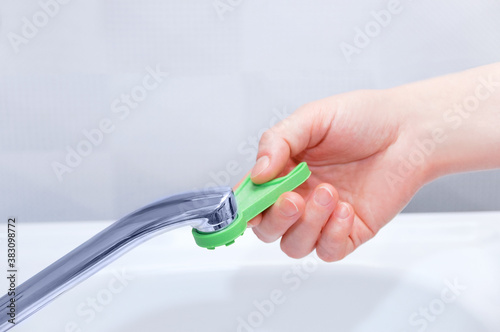 Unscrews the aerator on tap in the kitchen with a key.