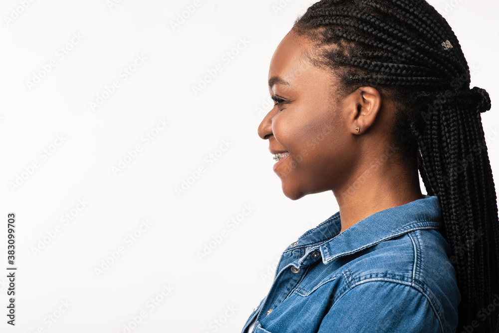 Obraz premium African Lady With Braided Hairstyle Posing Over White Background, Side-View
