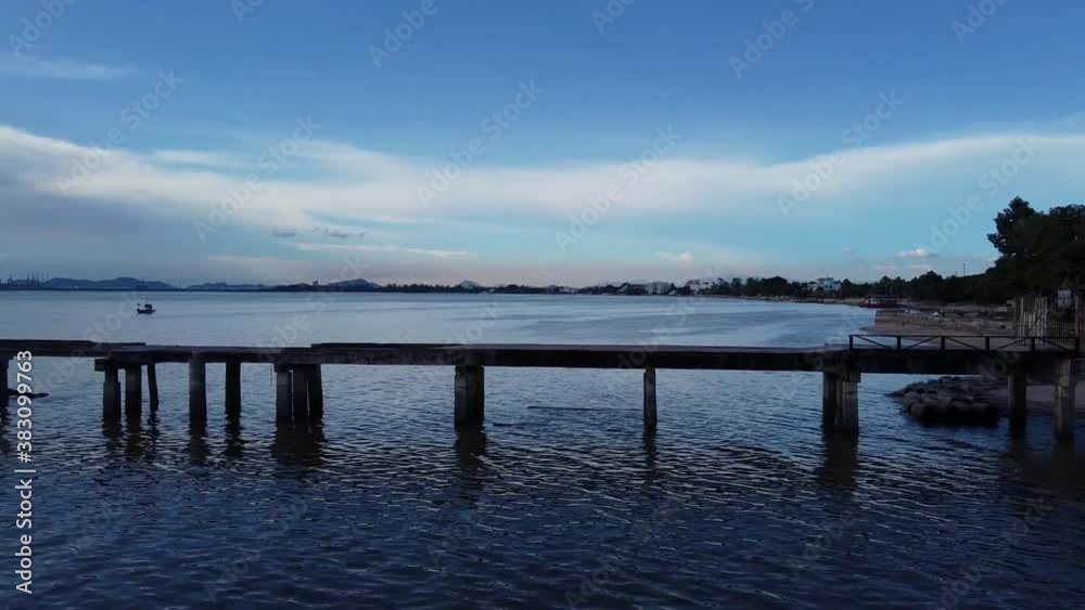 Sideways along Thai buddhist sea temple pier at blue hour late evening Sideways along Thai buddhist sea temple pier at blue hour late evening