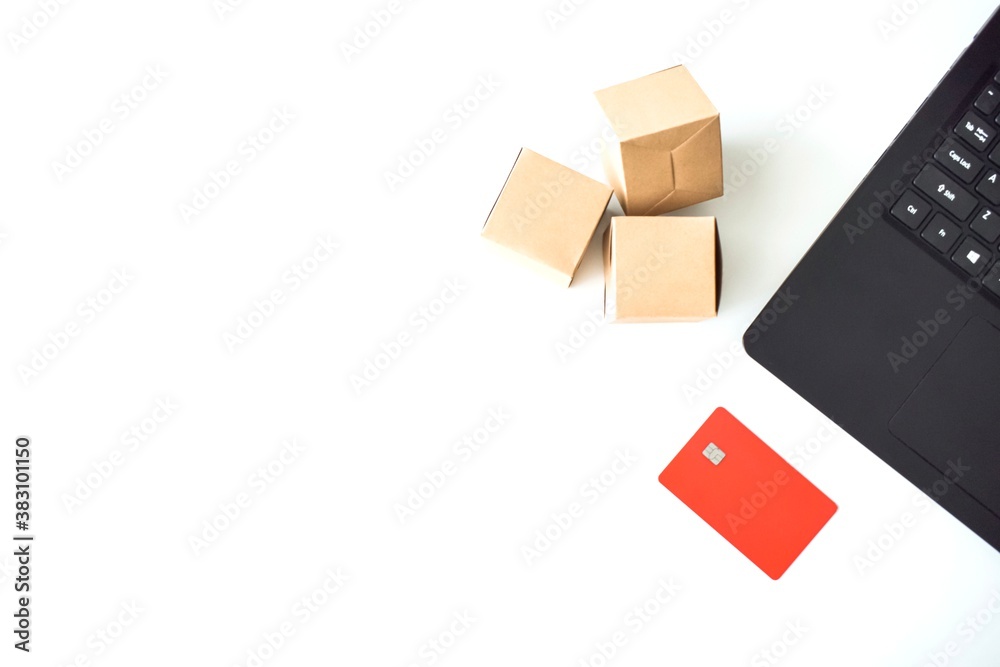 Online store. Purchase online. Paper boxes and credit cards in hand near the laptop. An online shopping service that offers home delivery. Online store. Purchase online. Paper boxes and credit cards in hand near the laptop. An online shopping service that offers home delivery.