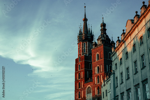 Saint Mary’s Basilica towers from Krakow square with light clouds and copy space