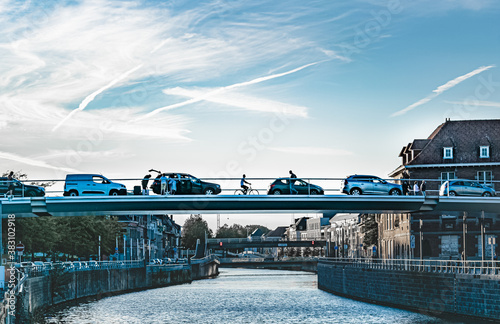 Cars and bicycle on the bridge in the town