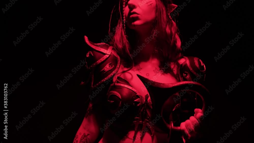 A costume on a girl for Halloween in the form of a warlike elf on a black background with smoke.