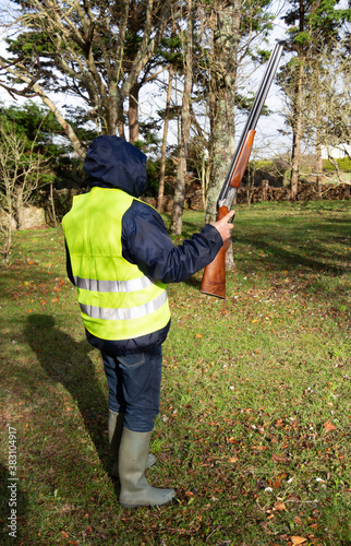 Hunter with its rifle in the woods in Brittany