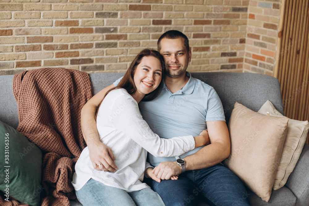 Happy loving couple hugging together at home. Family, love concept Happy loving couple hugging together at home. Family, love concept