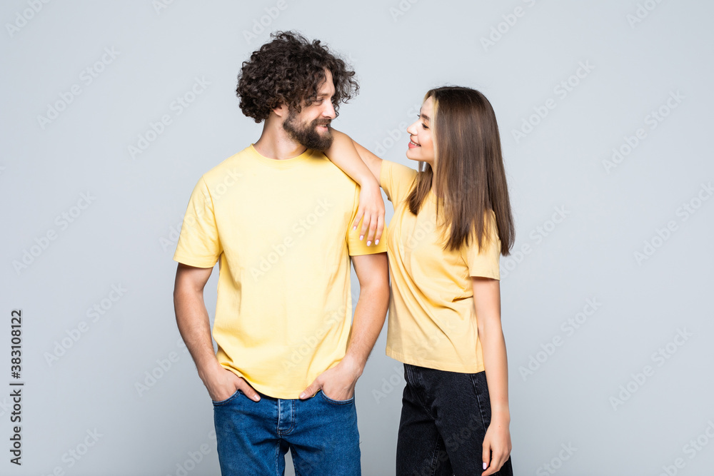 Happy couple embracing isolated against on gray background Happy couple embracing isolated against on gray background
