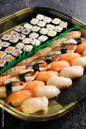 Japanese cuisine. Set of rolls and sushi on a black table. Food delivery. Background image, copy space