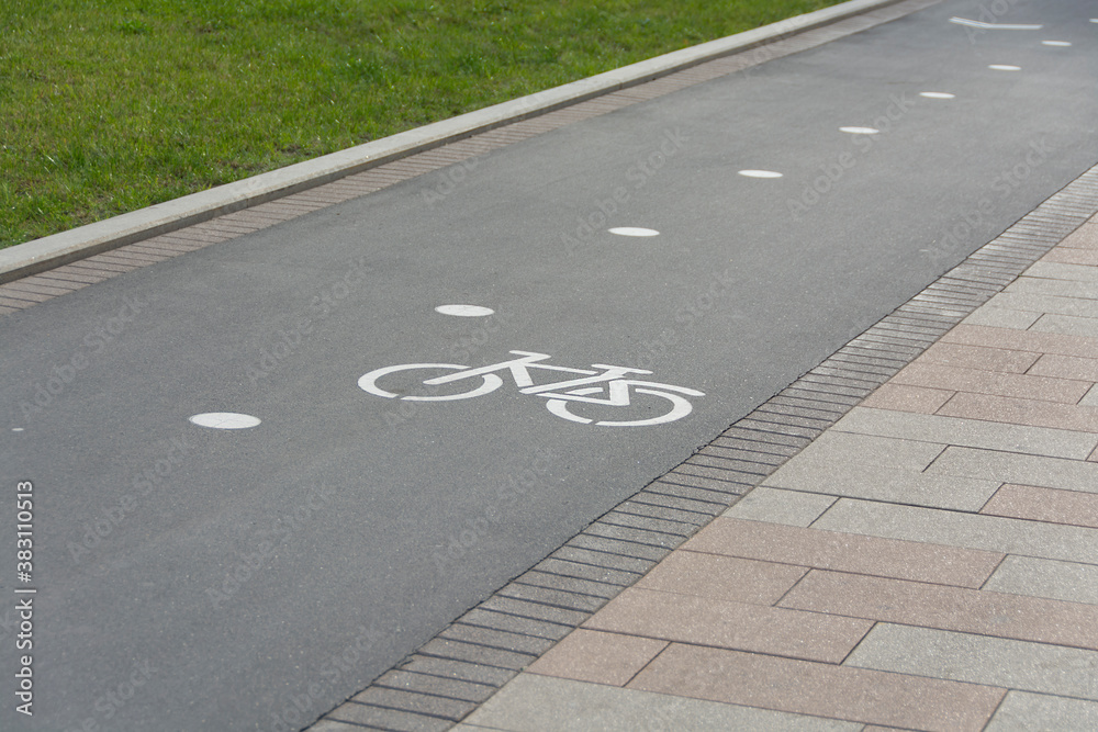 Fototapeta premium a special path with signs for cyclists in the city park