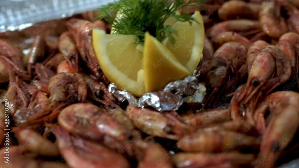 Close-up fried shrimps with cut lemon and dill in plastic box on table. HD Close-up fried shrimps with cut lemon and dill in plastic box on table. HD