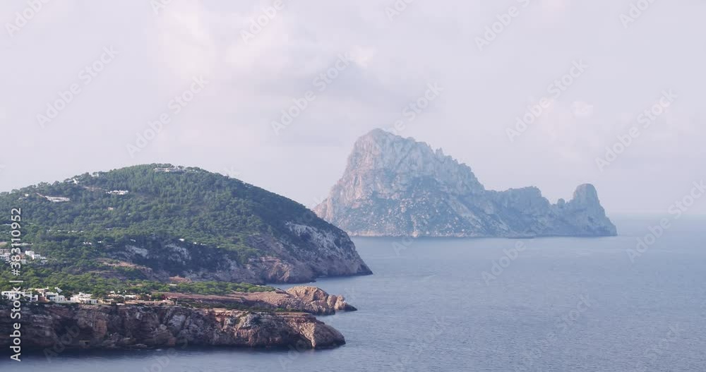 Es Vedra, Ibiza coastline, Balearic Islands, Cala Tarida cliffs and beach, stunning aerial footage of the mediterranean sea Es Vedra, Ibiza coastline, Balearic Islands, Cala Tarida cliffs and beach, stunning aerial footage of the mediterranean sea
