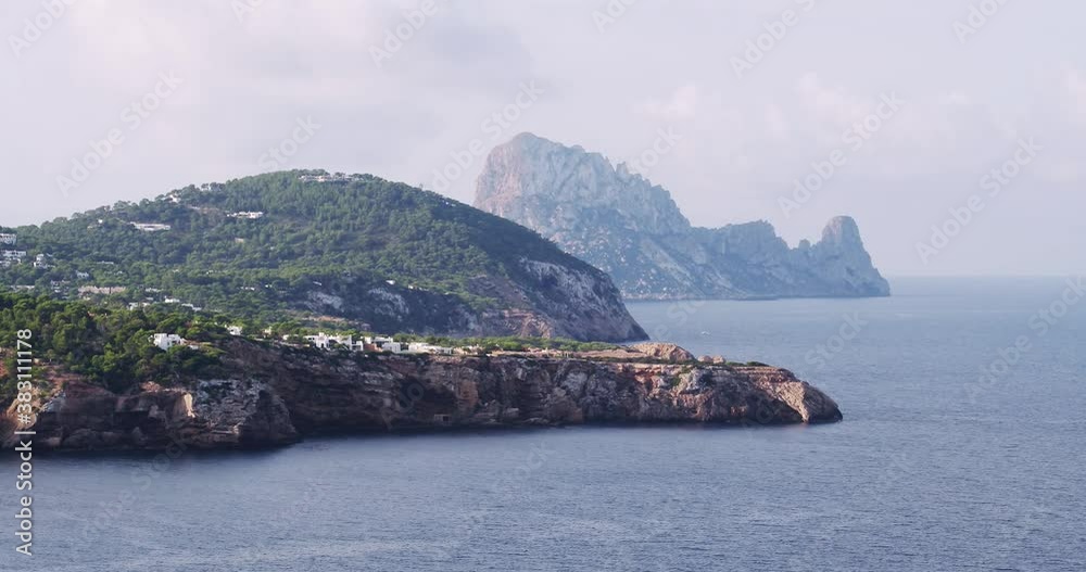Es Vedra, Ibiza coastline, Balearic Islands, Cala Tarida cliffs and beach, stunning aerial footage of the mediterranean sea Es Vedra, Ibiza coastline, Balearic Islands, Cala Tarida cliffs and beach, stunning aerial footage of the mediterranean sea