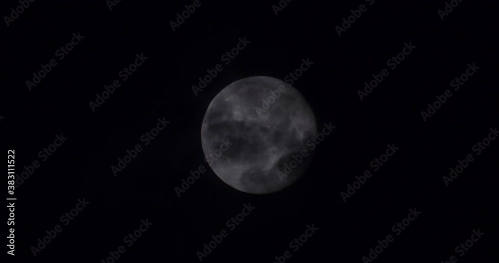 clouds passing by a full moon at night clouds passing by a full moon at night