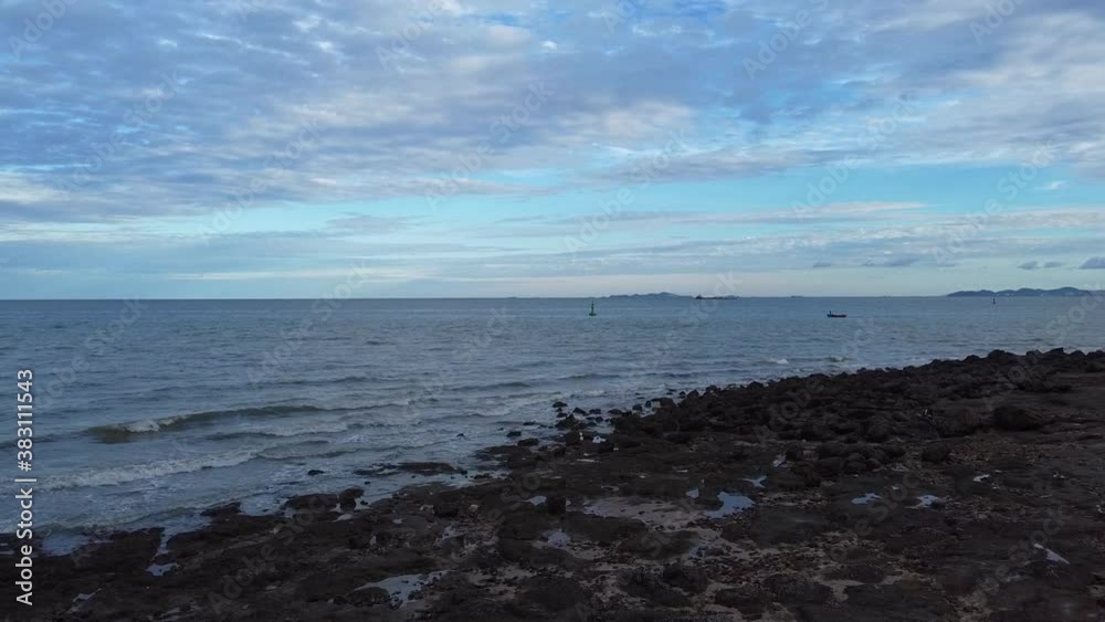 Fly low over rocky beach towards small fishing boat stunning sky Thailand Fly low over rocky beach towards small fishing boat stunning sky Thailand