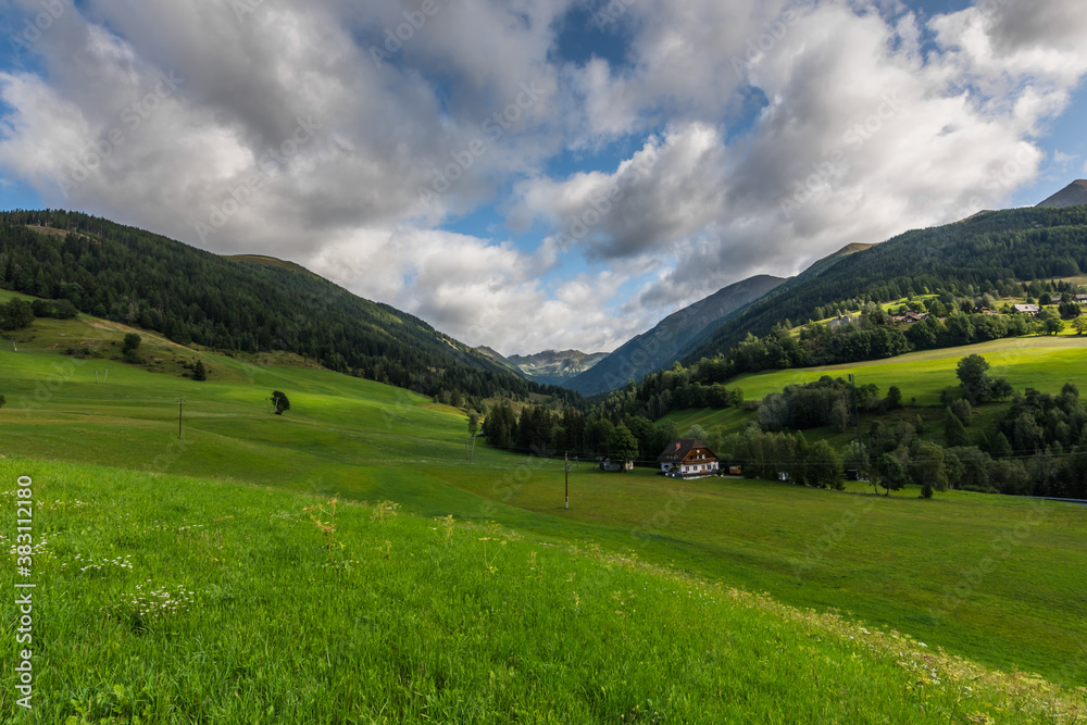 green nature landscape with mountains and meadows