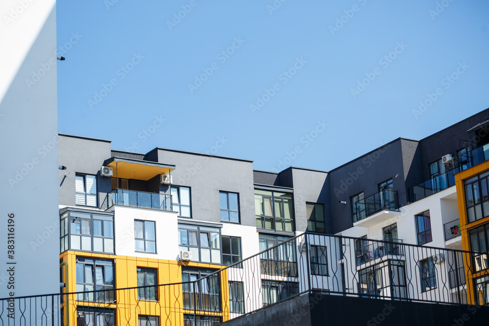 Large panoramic plastic windows. Facade of a new building in the house during construction work. Multi-storey building during construction