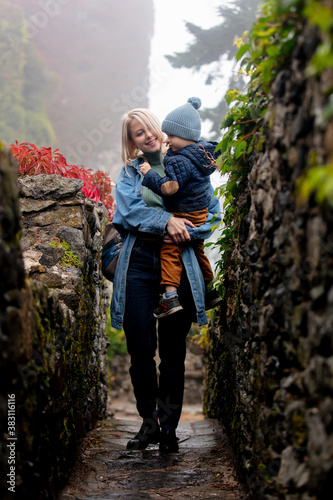 Mother and son near Virginia creeper in castle