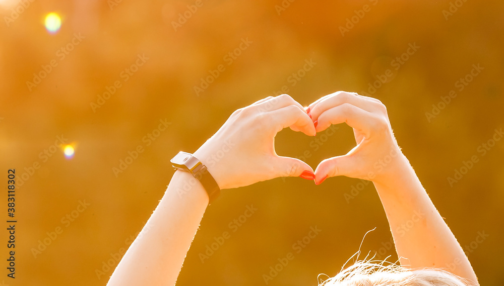 shot of heart symbol created from woman's hands over bright yellow foliage background at fine sunny autumn day. Have a good mood and be ready to fall in love at every season shot of heart symbol created from woman's hands over bright yellow foliage background at fine sunny autumn day. Have a good mood and be ready to fall in love at every season